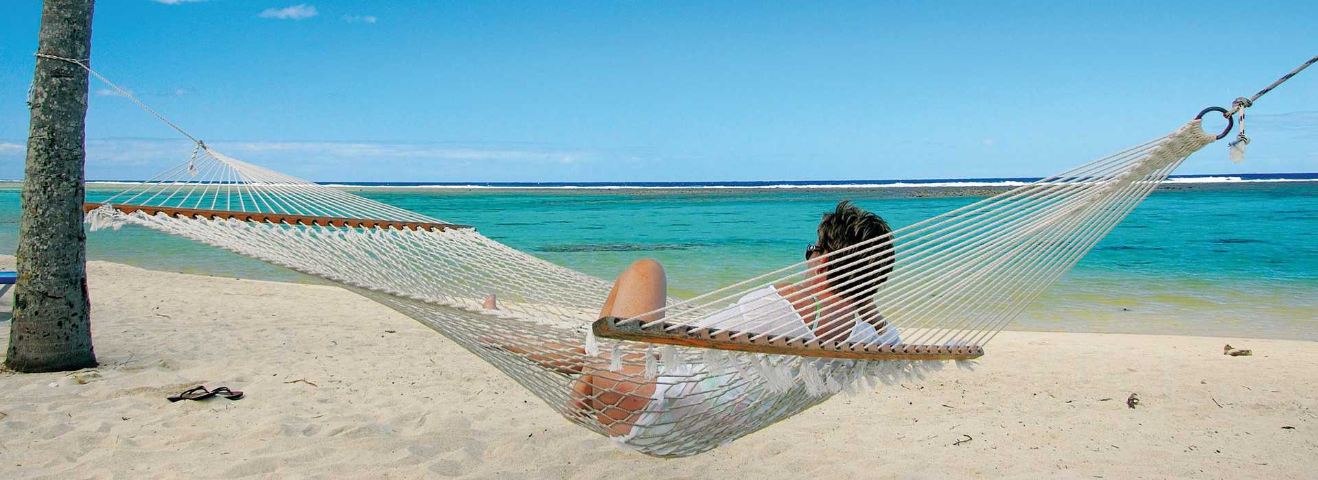 Woman relaxing in hammock on a Mozambique beach