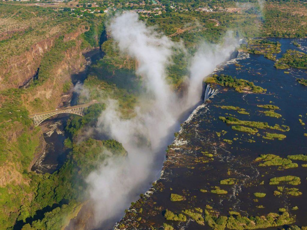 An aeria shot over victoria falls showing the bride and the town of Victoria Falls.